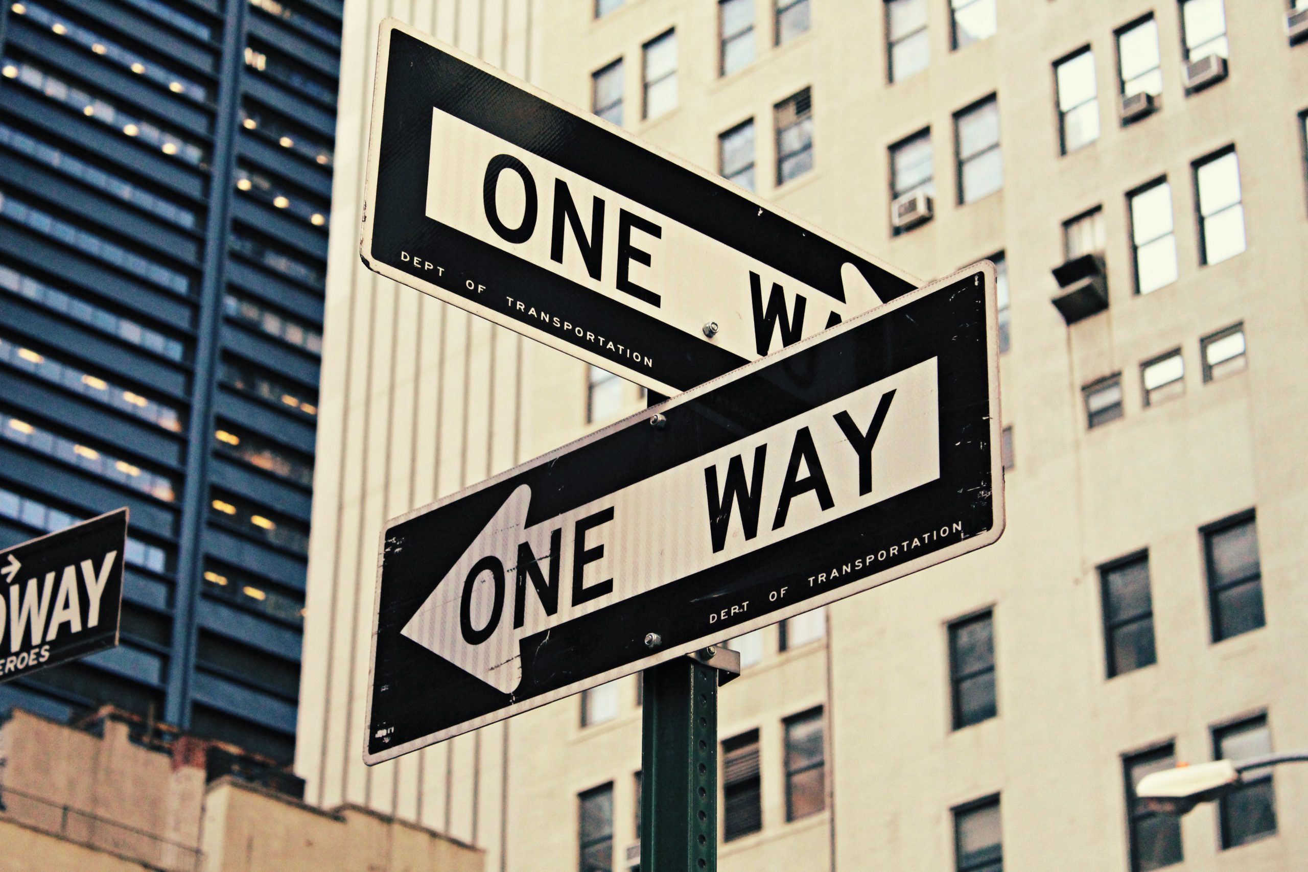 Conflicting street signs saying "one way"